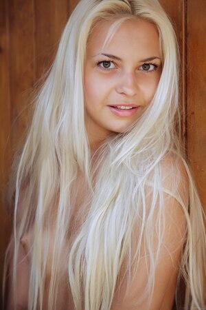 Cute blonde with sexy tan lines exposes her assets in front of the door