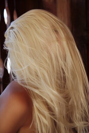 Cute blonde with sexy tan lines exposes her assets in front of the door