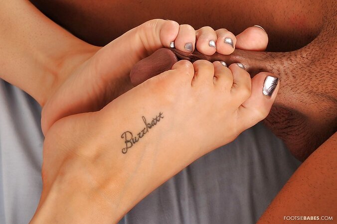 Dude enjoys having his big dick stroked with babe's feet in the clinic