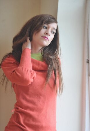 Sensitive brunette girl enjoys herself while revealing underwear by the window