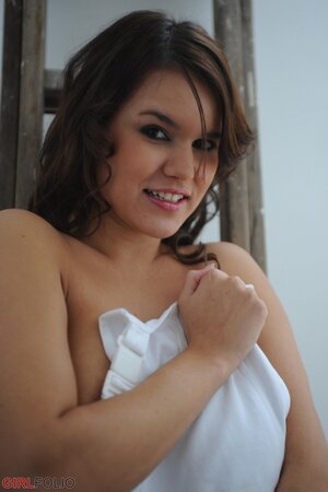 Chubby honey exposes her huge naturals while posing naked on the ladder