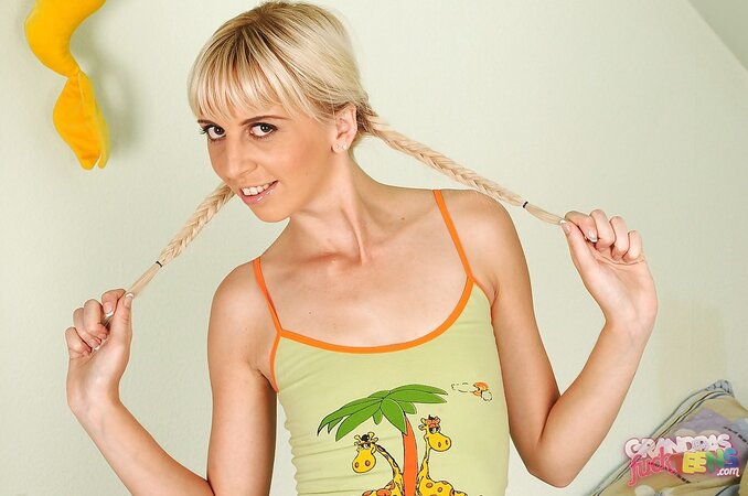 Skinny belle with pigtails spreads pussy lips to expose her pink holes