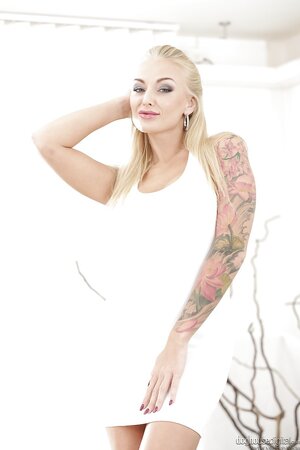 Blonde whore with big fake tits and tattoos makes men fantasize about her