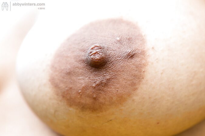 Whitney the horny babe is petting her black pussy in a field