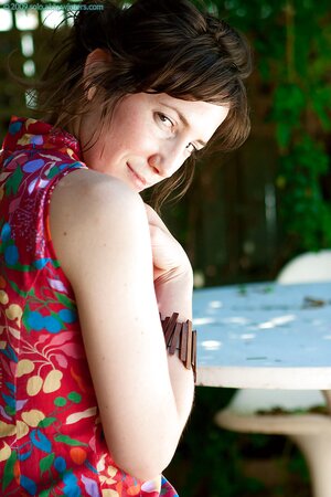 Brunette with natural breasts is going to showcase them outside