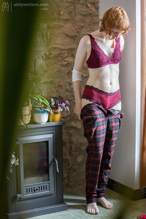 Redheaded cutie puts on her pants and looks very, very good