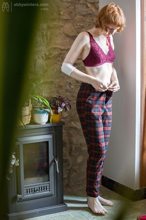 Redheaded cutie puts on her pants and looks very, very good