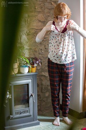 Redheaded cutie puts on her pants and looks very, very good