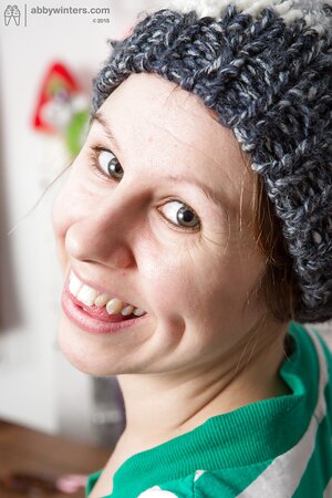 Girl with a cute smile shows her boobs in see through bra