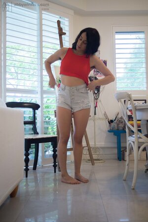 She is going to fix her hair and show her perfect backside