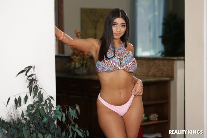 Charming gal winks at you before exposing her insane curves