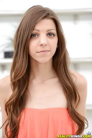 Brunette with a charming face pets her pussy and enjoys fingering