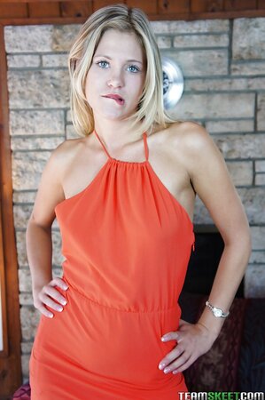 Fantastic beauty is smiling while showing off her new red dress