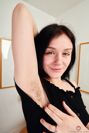 Petite teen takes off her black dress to reveal her curves