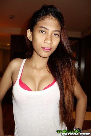 Skinny Thai teen shows off her perky tits and a hairy pussy