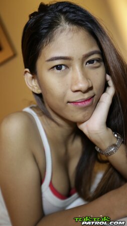 Skinny Thai teen shows off her perky tits and a hairy pussy