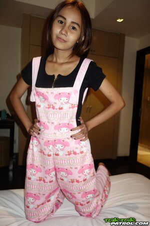 Edgy Thai babe named Puy is going to smoke and tease in overalls