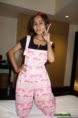 Edgy Thai babe named Puy is going to smoke and tease in overalls