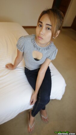 Young Thai babe shows her natural boobs and pretty face