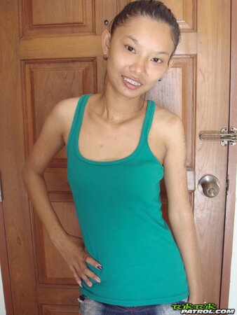 Skinny Asian girl is going to show nude body in a doorway