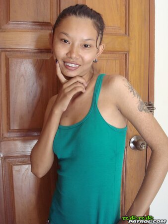 Skinny Asian girl is going to show nude body in a doorway