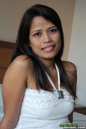 Thai babe shows the outline of her meaty pussy in a skirt first