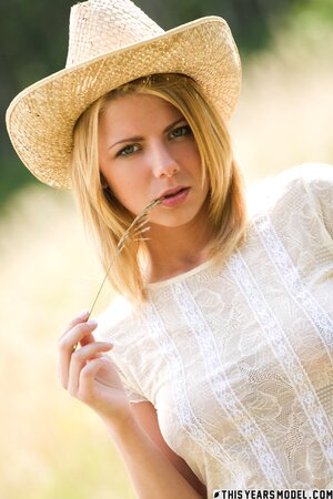 Hot blonde strips down to pose naked not far from her farm