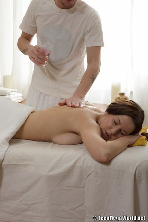 Tight bodied and oily girl gets fucked sideways on massage table