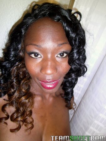 Horny ebony takes pics of her big round boobs to attract dicks