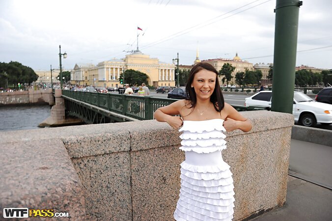 Tanned and leggy girl shows off in a large city to be a teaser