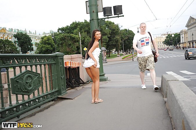 Tanned and leggy girl shows off in a large city to be a teaser