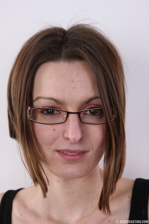 Geeky babe with natural boobs is showing off her backside too