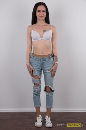 Pretty girl with sexy jeans on shows her tattoos and great pussy