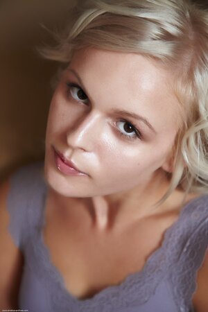 Her oval face is framed by thin eyebrows and perky ears