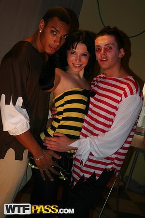 Gazes directly into the camera, her eyes sparkling with mischief