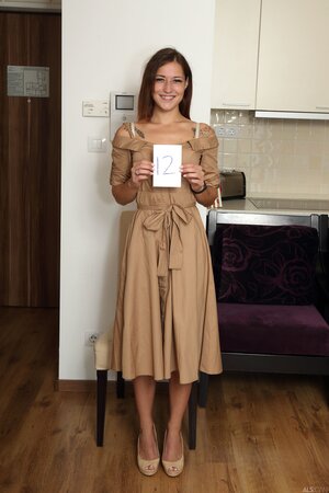 Mina K smiling as she removes her dress and flaunts her goods