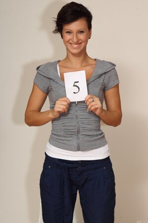 Emilia Argan strips and shows her tanned body