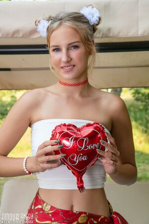 Beautiful blonde teen Nana gets naked on the bench swing