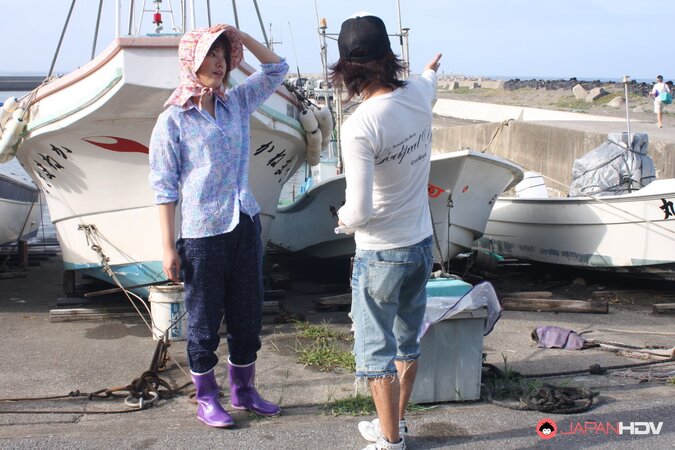 Japanese girl gets pleasured through her pants in rubber boots