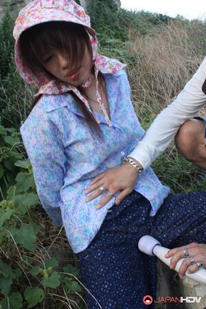 Japanese girl gets pleasured through her pants in rubber boots