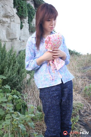 Japanese girl gets pleasured through her pants in rubber boots