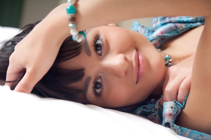 Cute teen Shereen A reveals her hairy pussy and poses on a bed