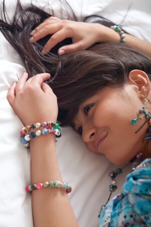 Cute teen Shereen A reveals her hairy pussy and poses on a bed