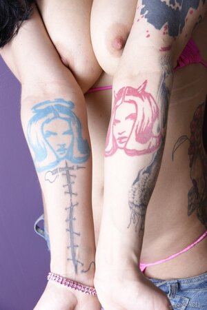 Bella Vendetta displays her natural big tits, nice ink, and pierced pussy in a bikini