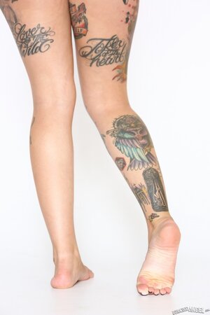 Tattooed girl with a fat ass and thick thighs getting naked