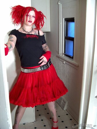 Fetish chick with flaming red hair spreads her chubby pussy wide in the bathroom