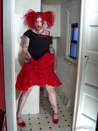 Fetish chick with flaming red hair spreads her chubby pussy wide in the bathroom