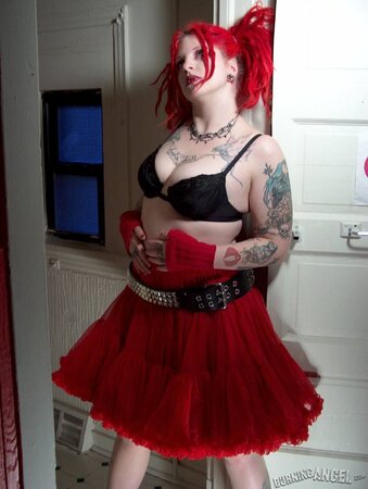 Fetish chick with flaming red hair spreads her chubby pussy wide in the bathroom