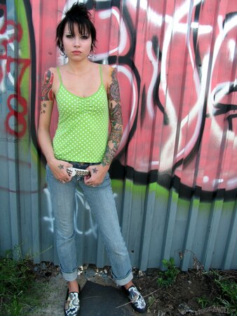 Black-haired young cutie shows off her tiny ass outdoors while stripping to her belt