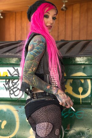 Kelsi Lynn shows off her petite ass and pussy beside the dumpster while smoking